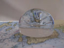 Clear glass dome over a small figurine on a map background