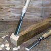 Set of chisels and a mallet on a wooden surface
