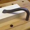 Metallic handle on a wooden surface