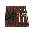 Set of chisels on a brown apron with a green strap.